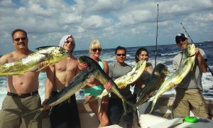 Group of people on a shared charter posing with some nice mahi-mahi they caught fishing offshore Fort Lauderdale.